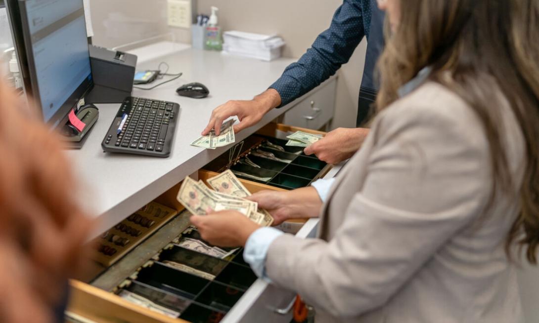 Cash manager counting money to deposit